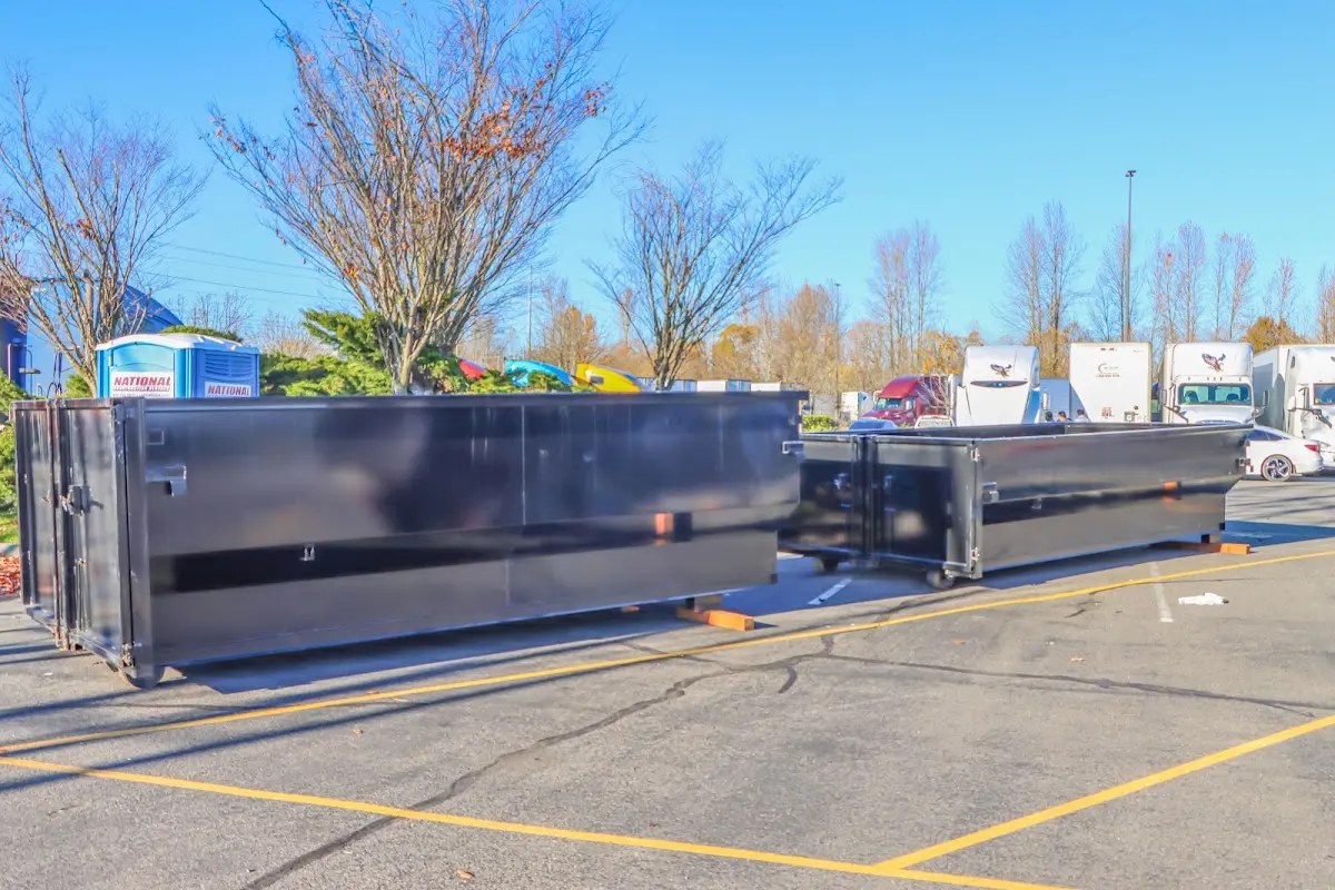 Professional dumpster rental service with roll-off container on residential driveway in Mamaroneck